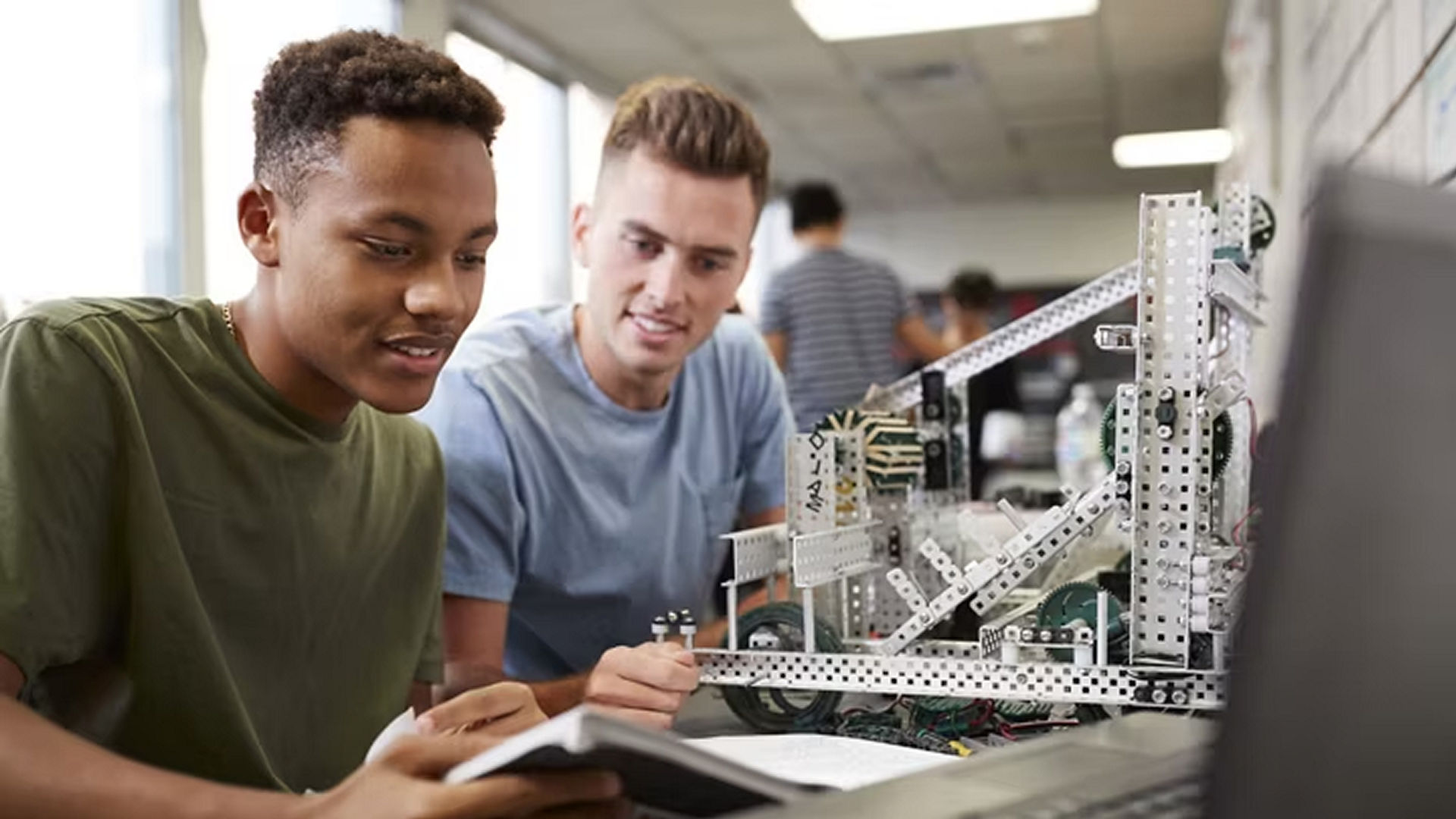 Image of 2 young people building a model.