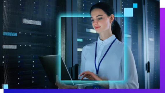 A data center professional uses a laptop in a work environment.